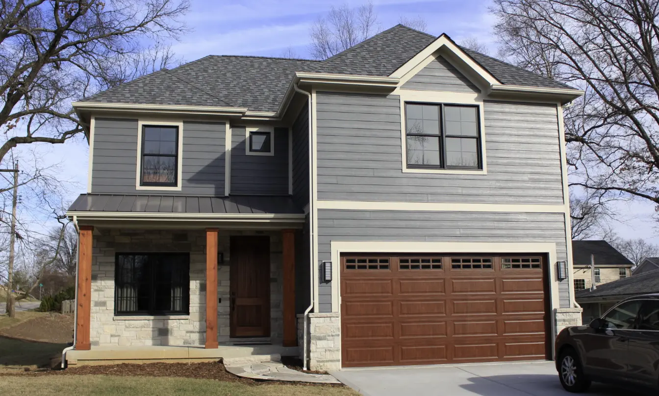 Warm wood-look front door replacement on Canadian home porch with stone and wood accents