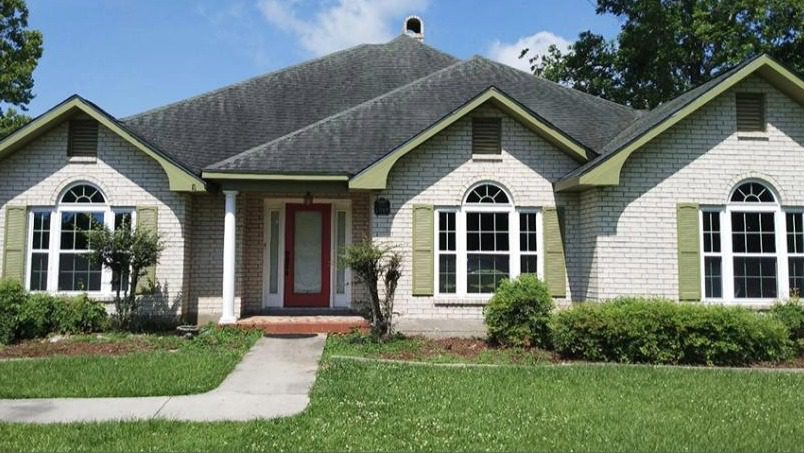Window style comparison on a home facade during replacement